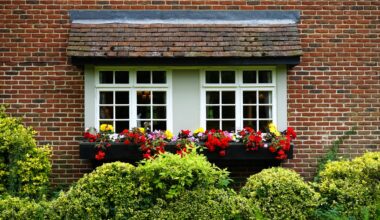 A home's outside windowsill covered in colorful flowers and shrubbery.