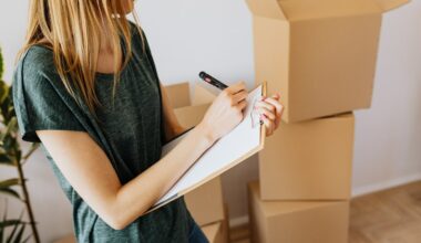Woman signing paperwork with moving boxes in the background