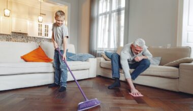 Older man and young boy cleaning the floors of their house