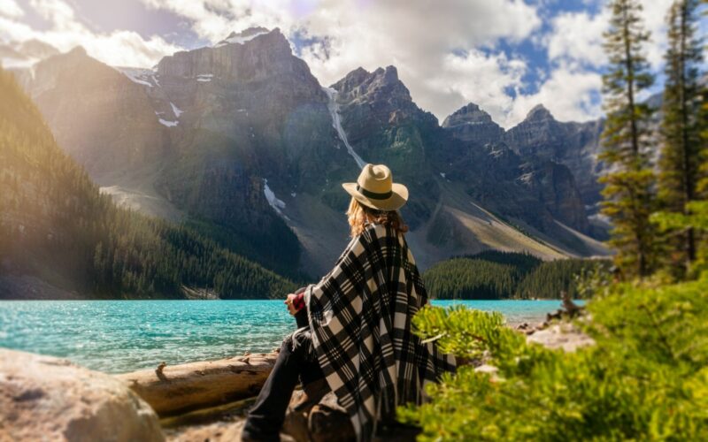 woman sitting by lake