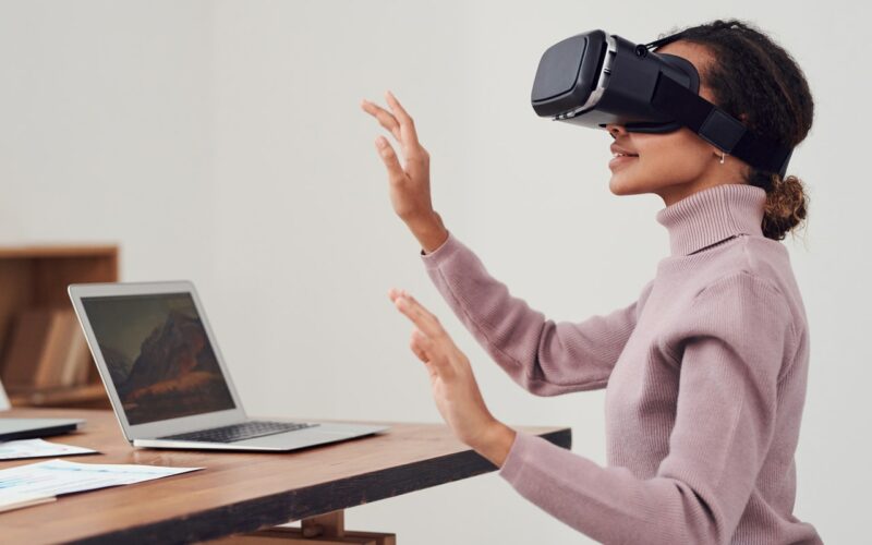 woman using virtual reality goggles to view virtual home tour